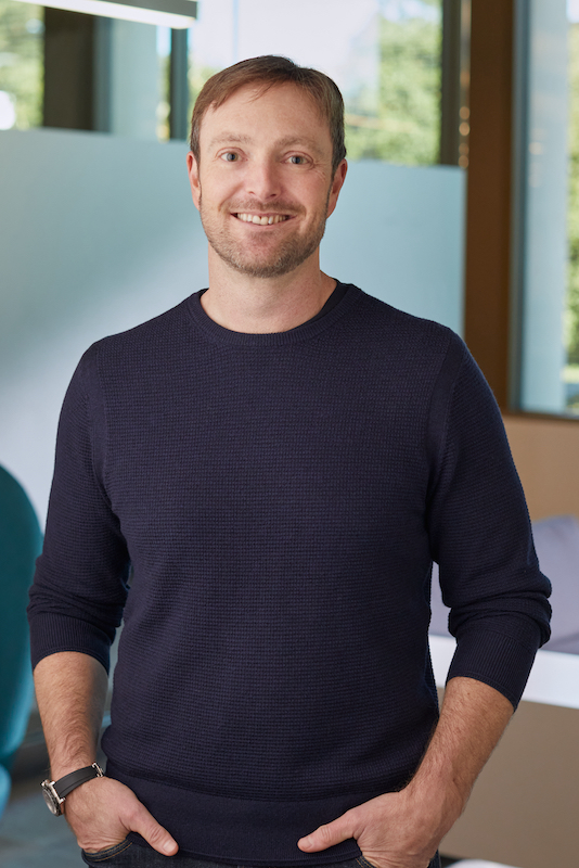 A headshot of Alex Chriss, PayPal's new President and CEO, smiling and looking at the camera.