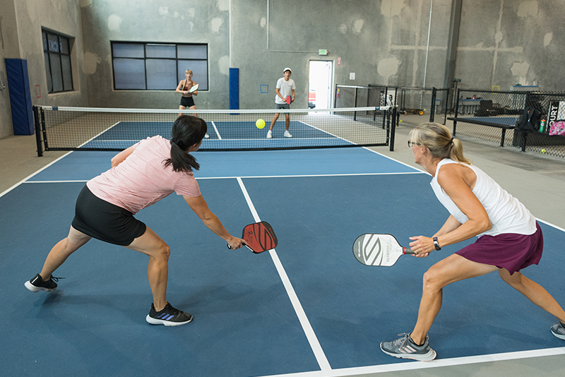 Two women playing pickle ball