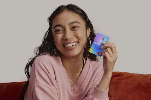 A teenage girl holding a Venmo Teen Debit Card.