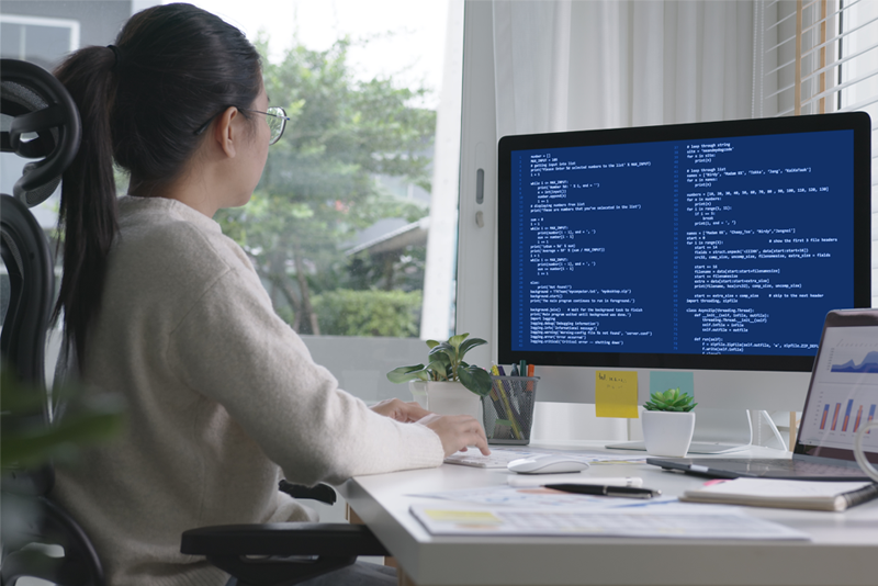 Woman working in front of desktop computer